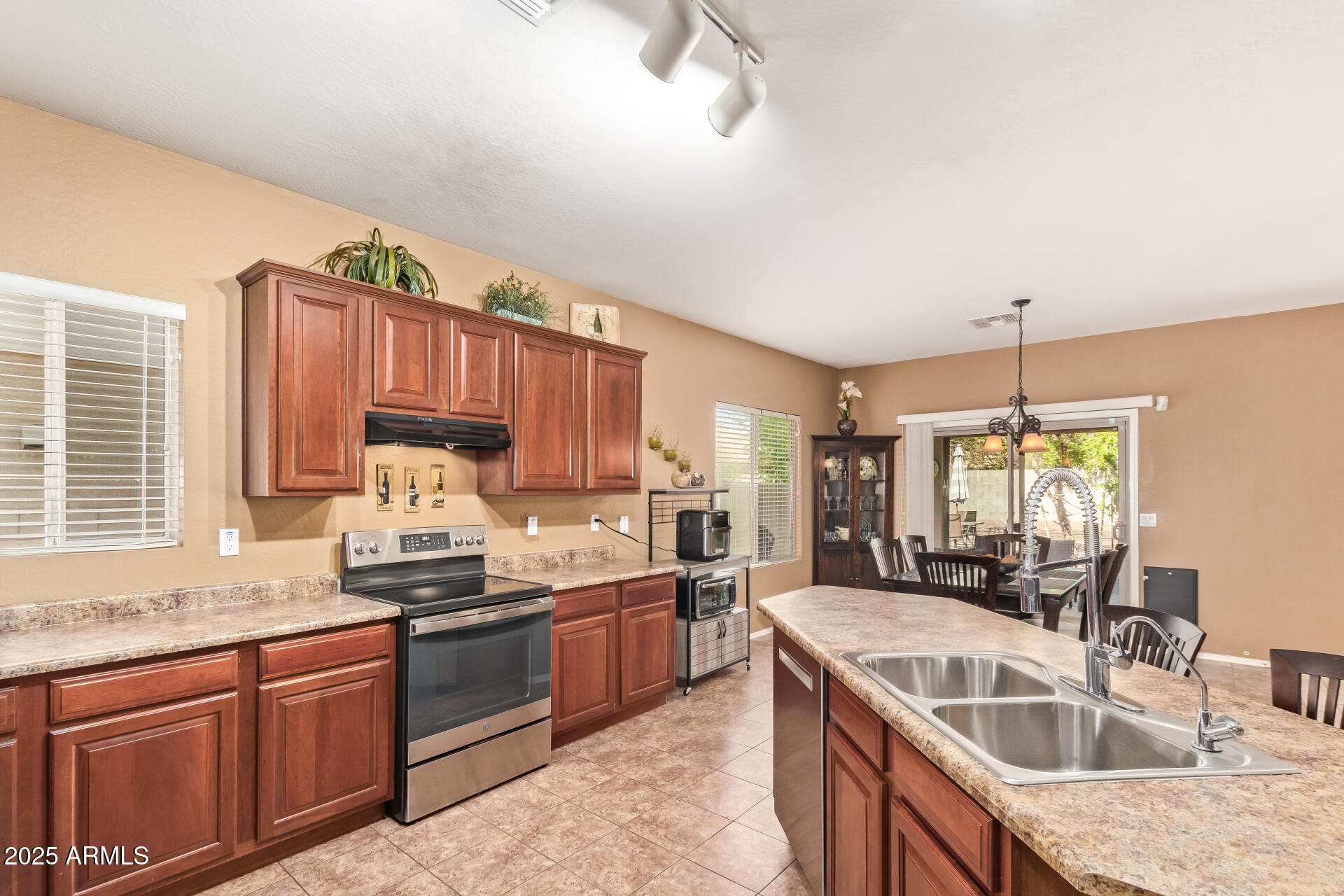 6934 West Beverly Road Laveen, AZ 85339 - Photo 11 of 31 a kitchen with granite countertop a sink stove and cabinets