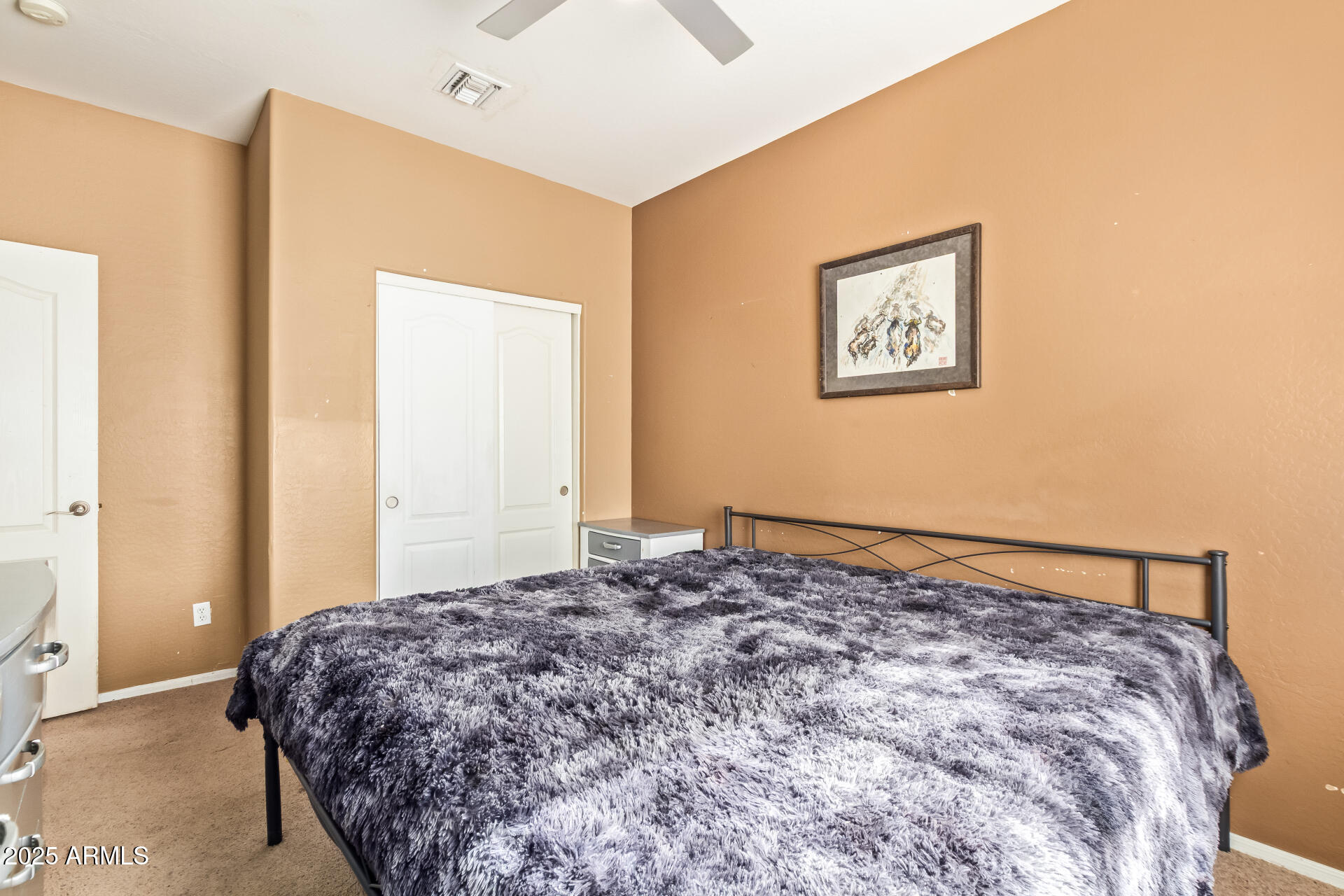 6934 West Beverly Road Laveen, AZ 85339 - Photo 20 of 31 a bedroom with a bed and painting on the wall