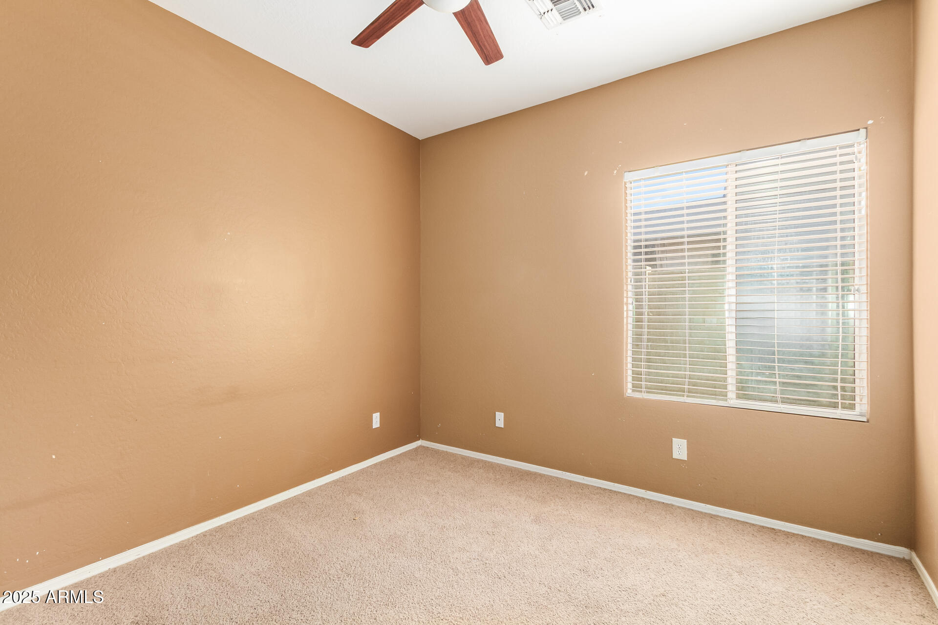 6934 West Beverly Road Laveen, AZ 85339 - Photo 22 of 31 a view of an empty room with a window