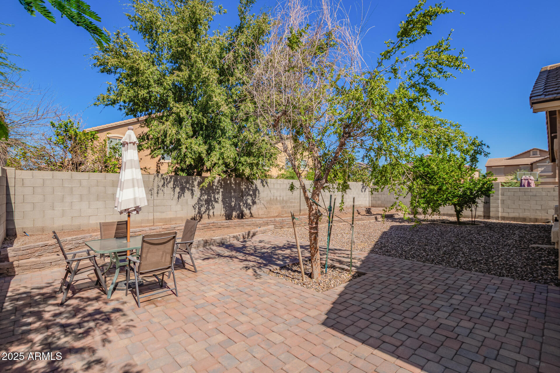 6934 West Beverly Road Laveen, AZ 85339 - Photo 27 of 31 a view of a patio with table and chairs and potted plants