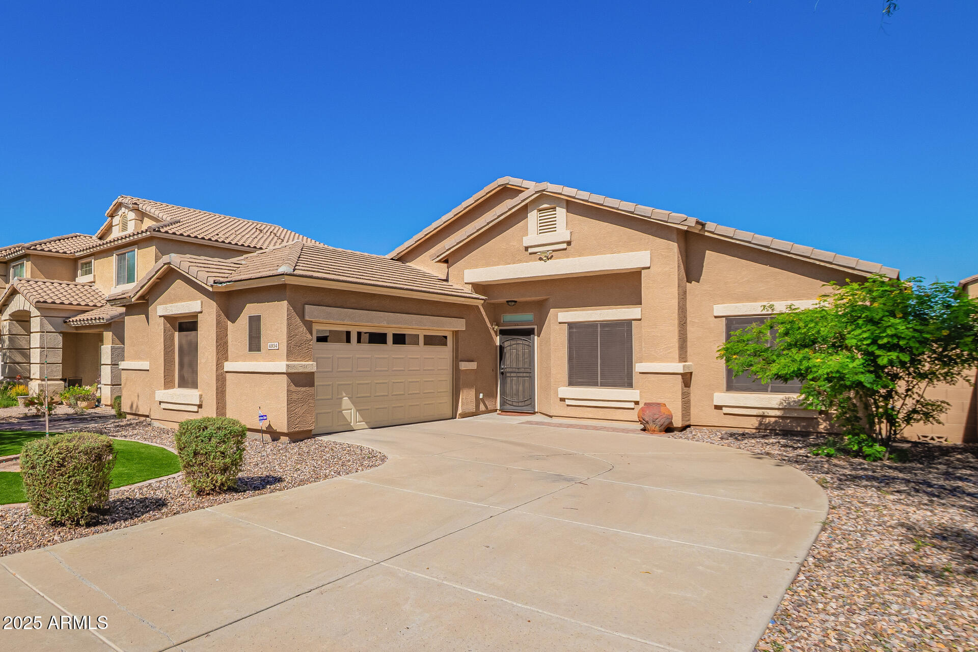 6934 West Beverly Road Laveen, AZ 85339 - Photo 2 of 31 a front view of a house with a garden