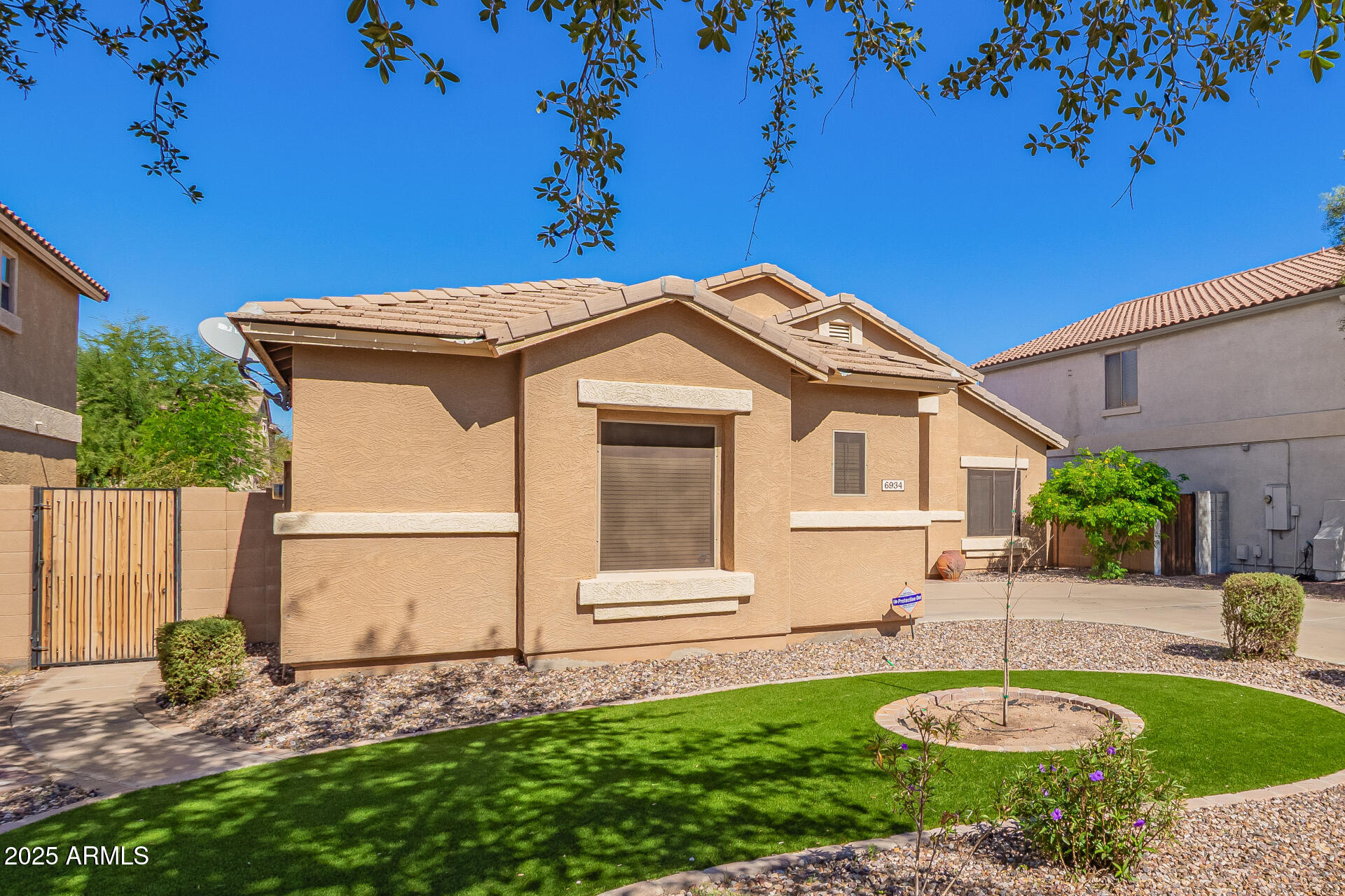 6934 West Beverly Road Laveen, AZ 85339 - Photo 3 of 31 a front view of a house with a yard