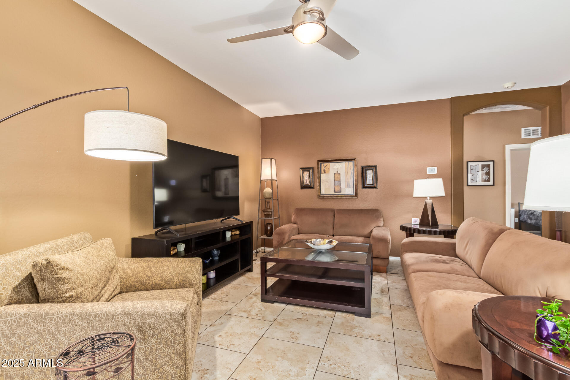 6934 West Beverly Road Laveen, AZ 85339 - Photo 5 of 31 a living room with furniture and a flat screen tv