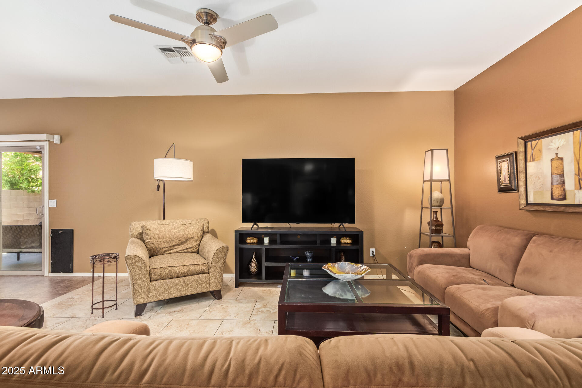 6934 West Beverly Road Laveen, AZ 85339 - Photo 6 of 31 a living room with furniture and a flat screen tv