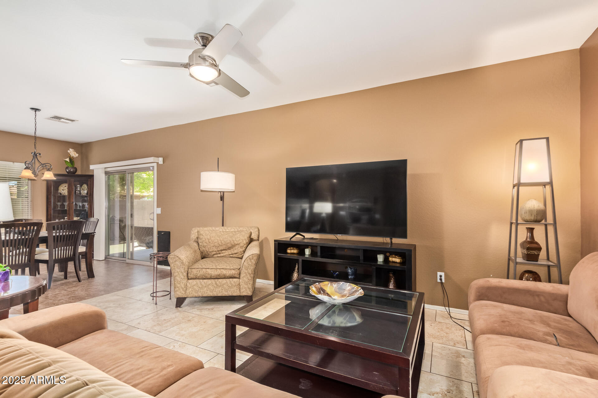 6934 West Beverly Road Laveen, AZ 85339 - Photo 7 of 31 a living room with furniture and a flat screen tv