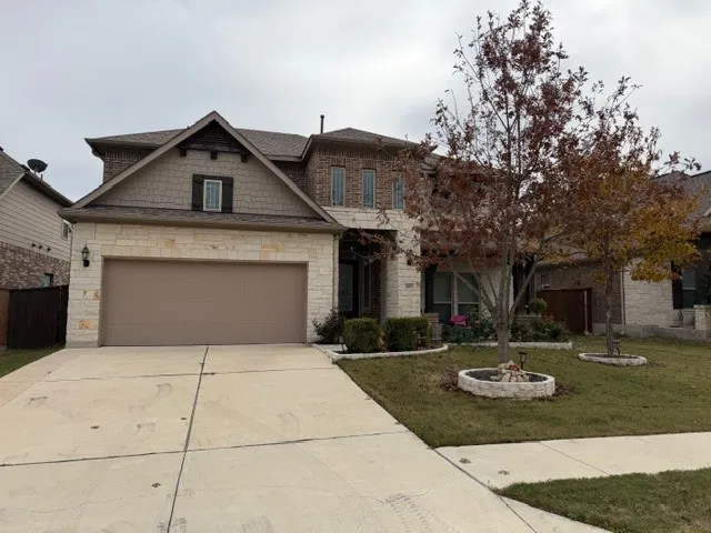 a front view of a house with yard garage and fire pit