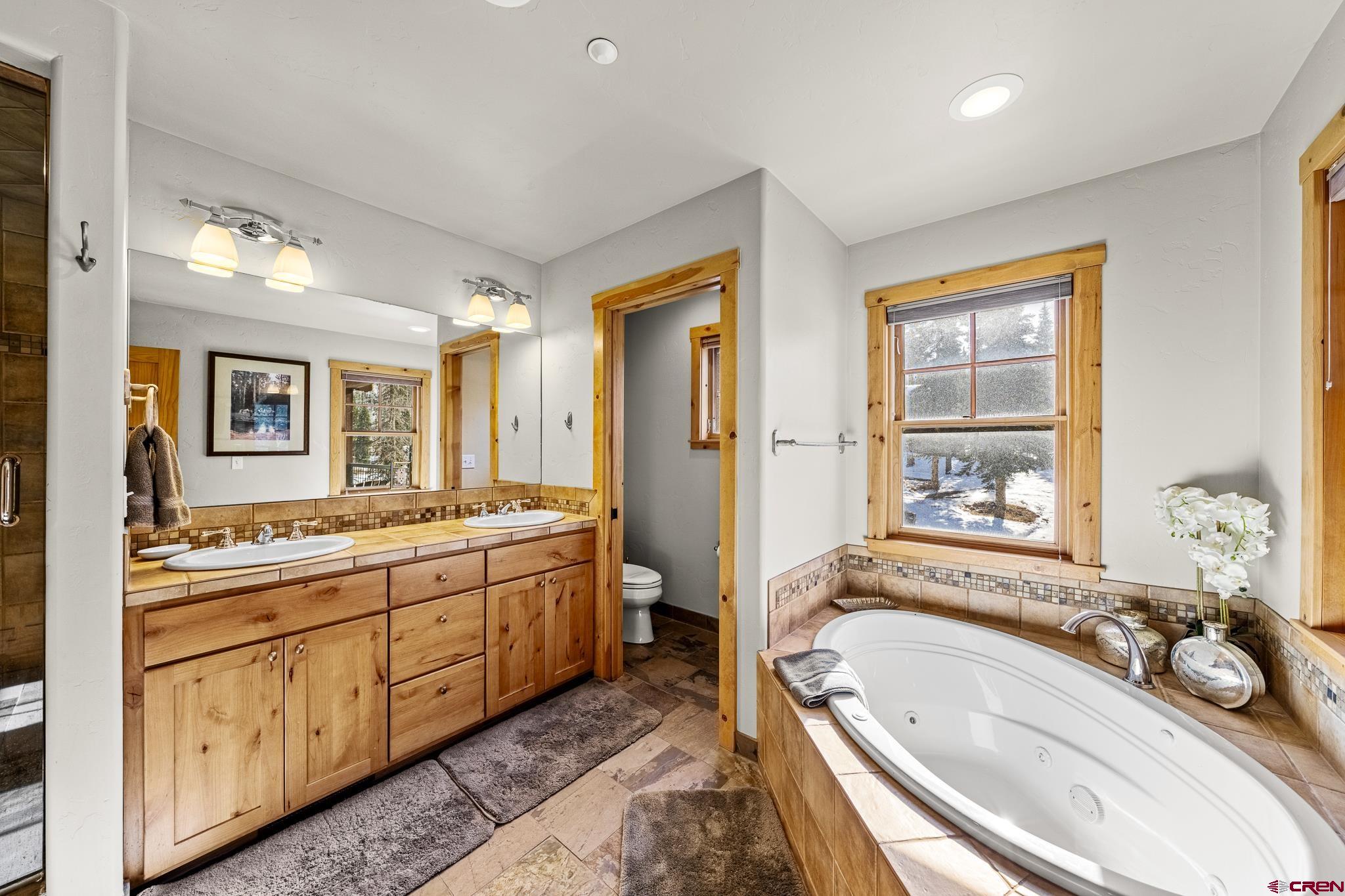 114 Limestone Court Durango, CO 81301 - Photo 24 of 35 a large spacious bathroom with a tub sink and mirror