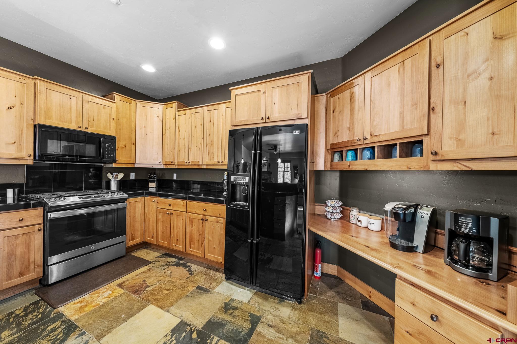 114 Limestone Court Durango, CO 81301 - Photo 5 of 35 a kitchen with stainless steel appliances granite countertop a refrigerator and sink