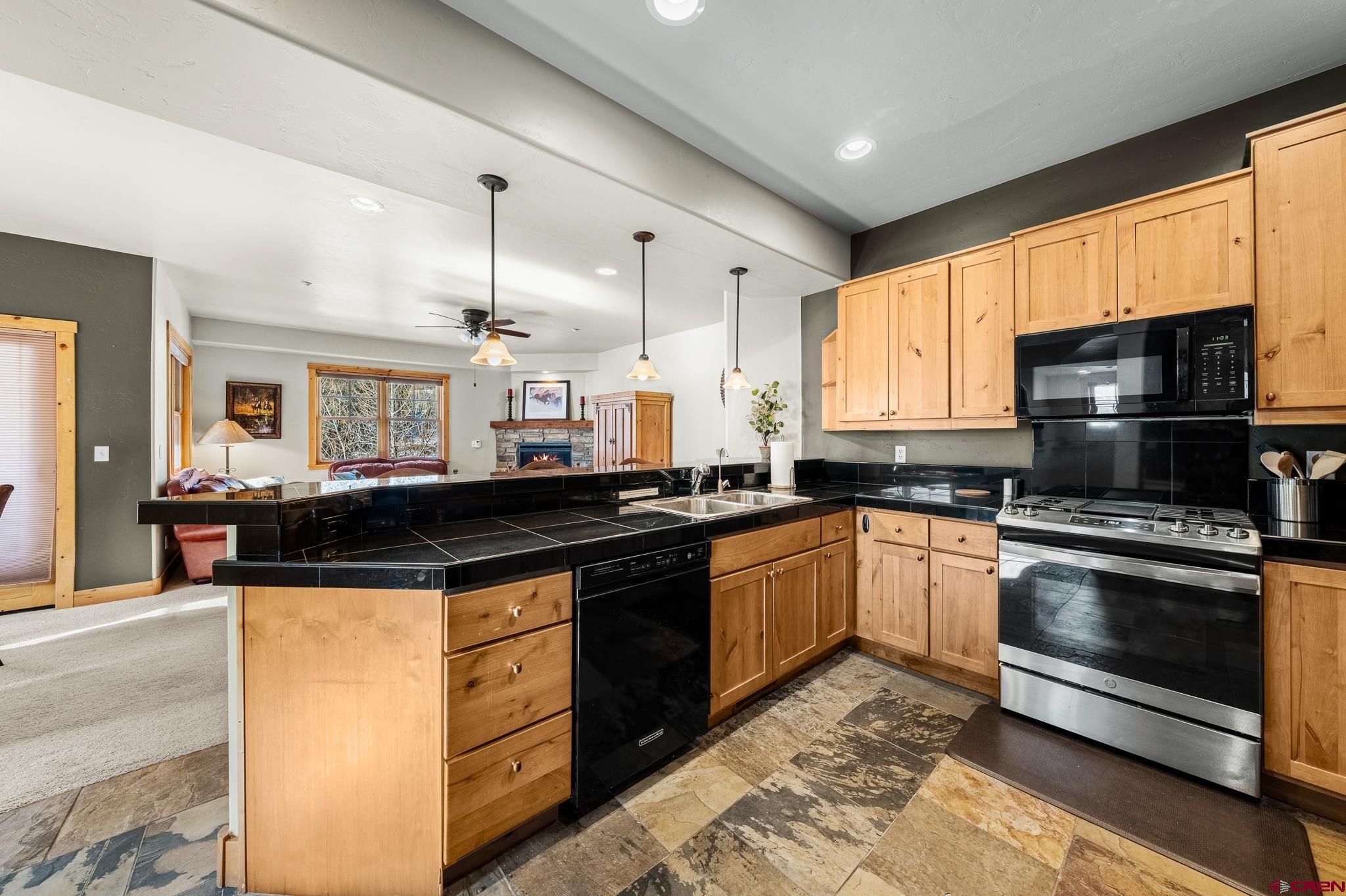 114 Limestone Court Durango, CO 81301 - Photo 6 of 35 a kitchen with stainless steel appliances granite countertop a stove a sink and a microwave