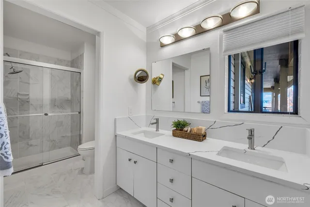 a bathroom with double sink and a mirror
