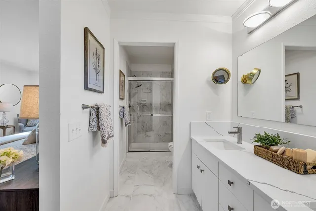 a spacious bathroom with a shower sink and mirror