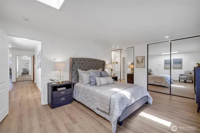 a bedroom with a bed and a view of kitchen