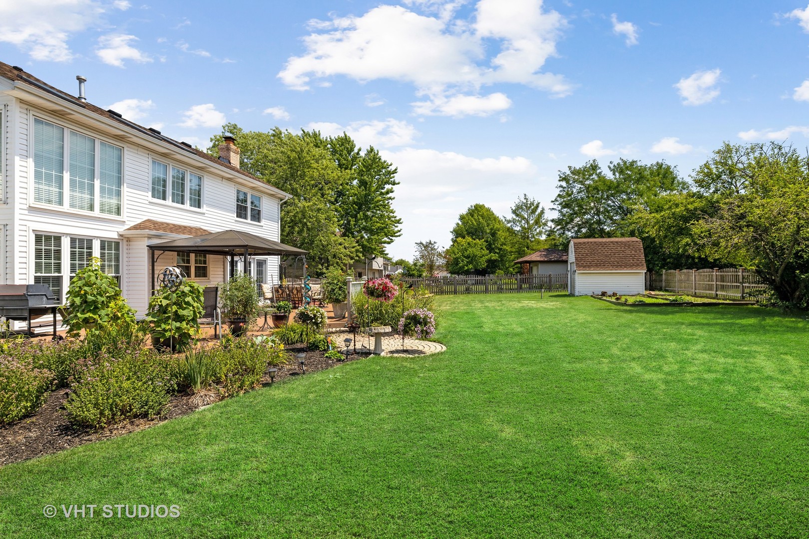 10001 Derby Lane Mokena, IL 60448 - Photo 27 of 31 a front view of a house with a garden and sitting area