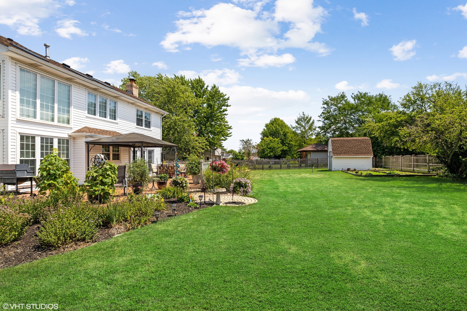 10001 Derby Lane Mokena, IL 60448 - Photo 28 of 31 a front view of a house with a garden and sitting area
