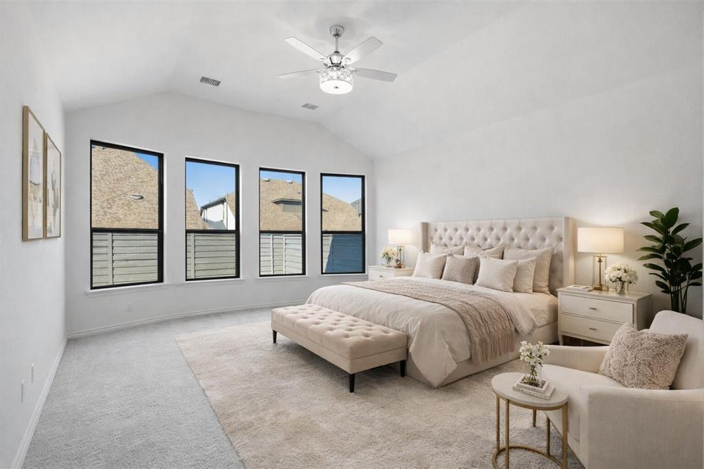 537 Oakmoss Street Little Elm, TX 76227 - Photo 13 of 39 a spacious bedroom with a bed a couch and large window