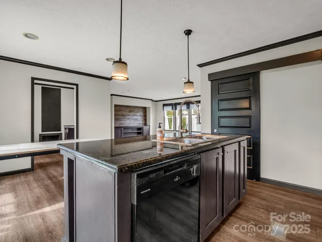 a kitchen with stainless steel appliances granite countertop a sink and a refrigerator