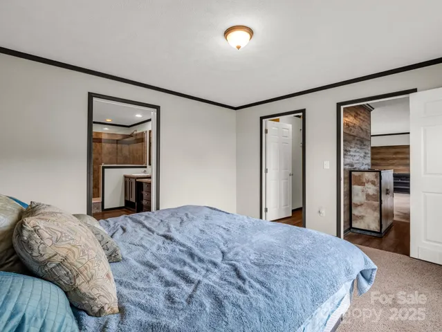 a bedroom with a large bed and a dresser