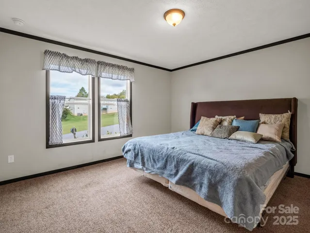 a bed sitting in a room next to a window