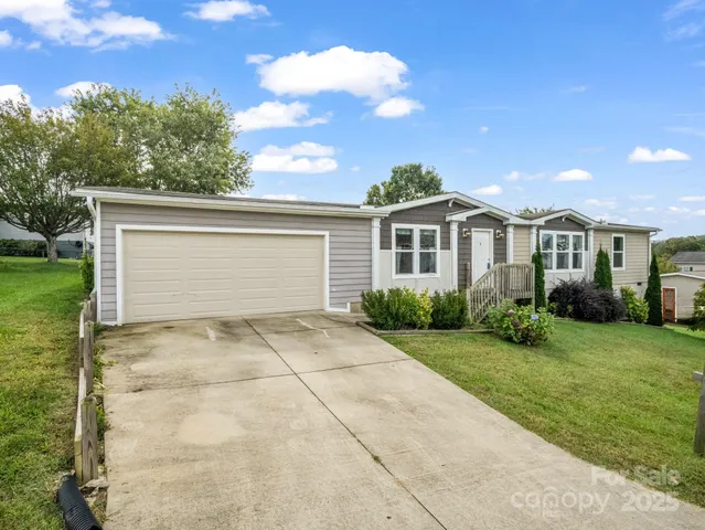 a view of backyard of house with green space