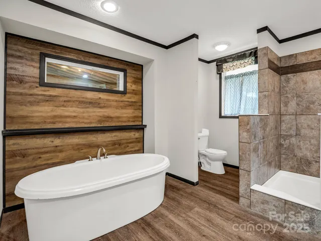 a bathroom with a toilet a sink and bathtub