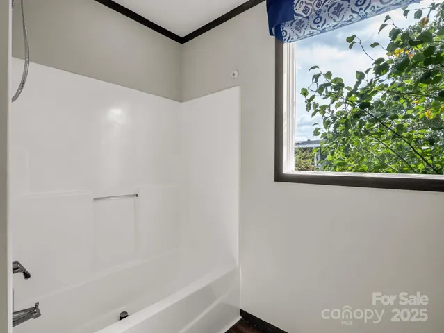 a bathroom with a bathtub and shower