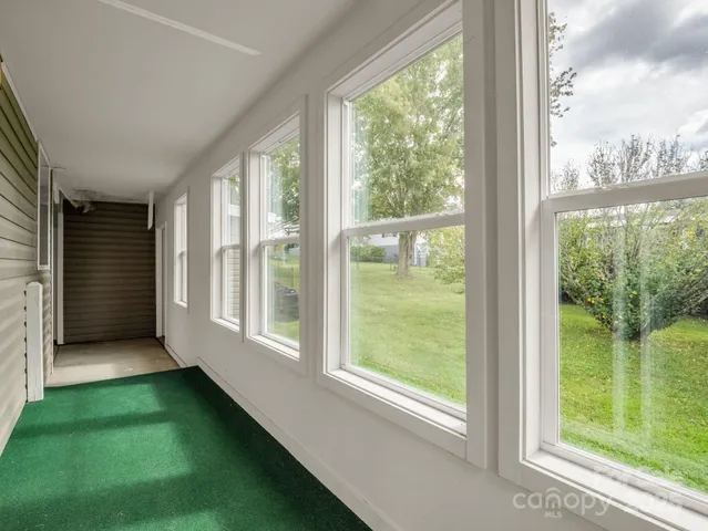 a view of an empty room with windows