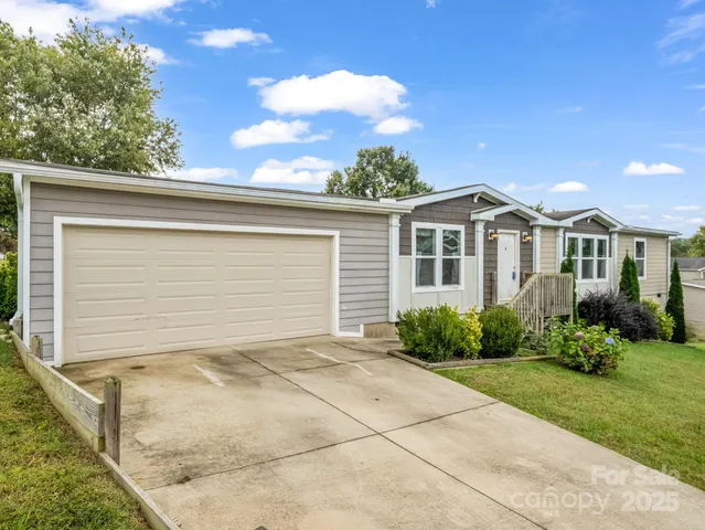 a view of backyard of house with green space