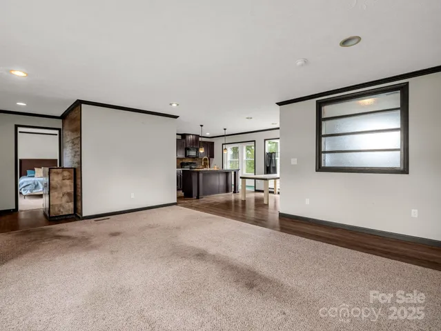 a view of a livingroom with an empty space and a window