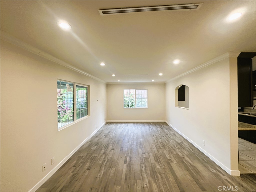 7307 Foothill Boulevard Tujunga, CA 91042 - Photo 4 of 27 an empty room with wooden floor and windows