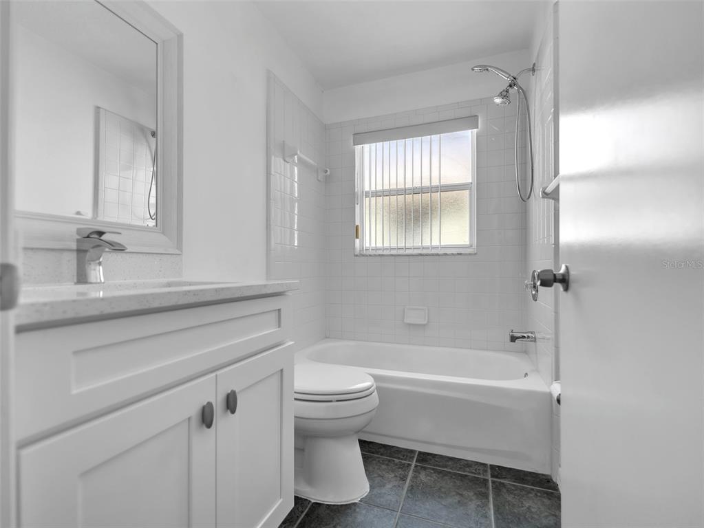 11606 Goodwyck Drive Orlando, FL 32837 - Photo 14 of 18 a bathroom with a sink toilet and shower