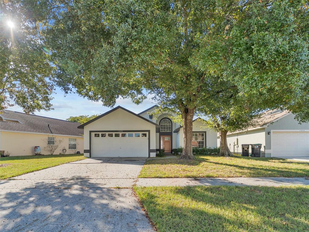 11606 Goodwyck Drive Orlando, FL 32837 - Photo 2 of 18 a view of a large pool with lawn chairs under an umbrella