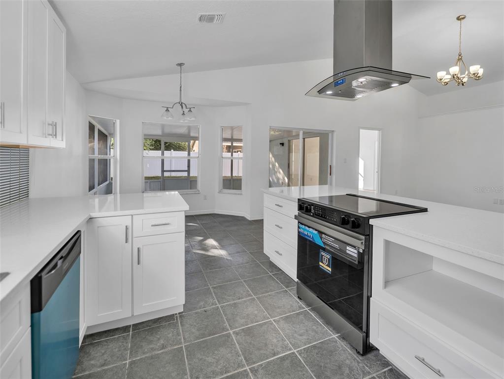 11606 Goodwyck Drive Orlando, FL 32837 - Photo 6 of 18 a kitchen with a stove cabinets and window