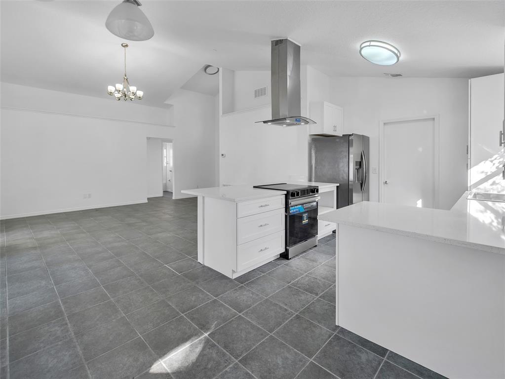 11606 Goodwyck Drive Orlando, FL 32837 - Photo 7 of 18 a large kitchen with cabinets and stainless steel appliances