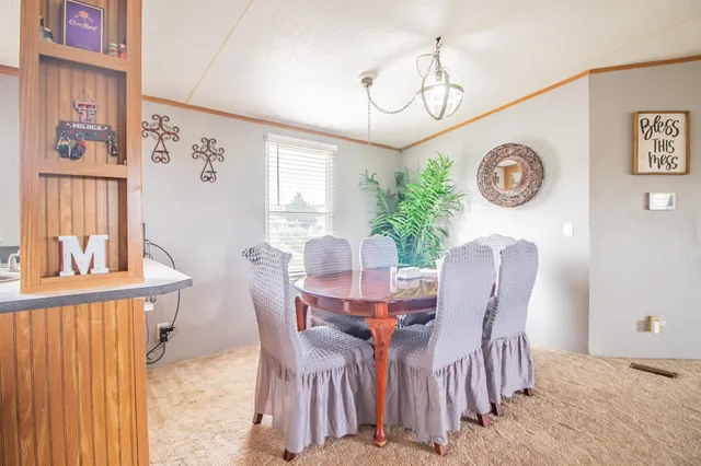 a view of a dining room with furniture and window