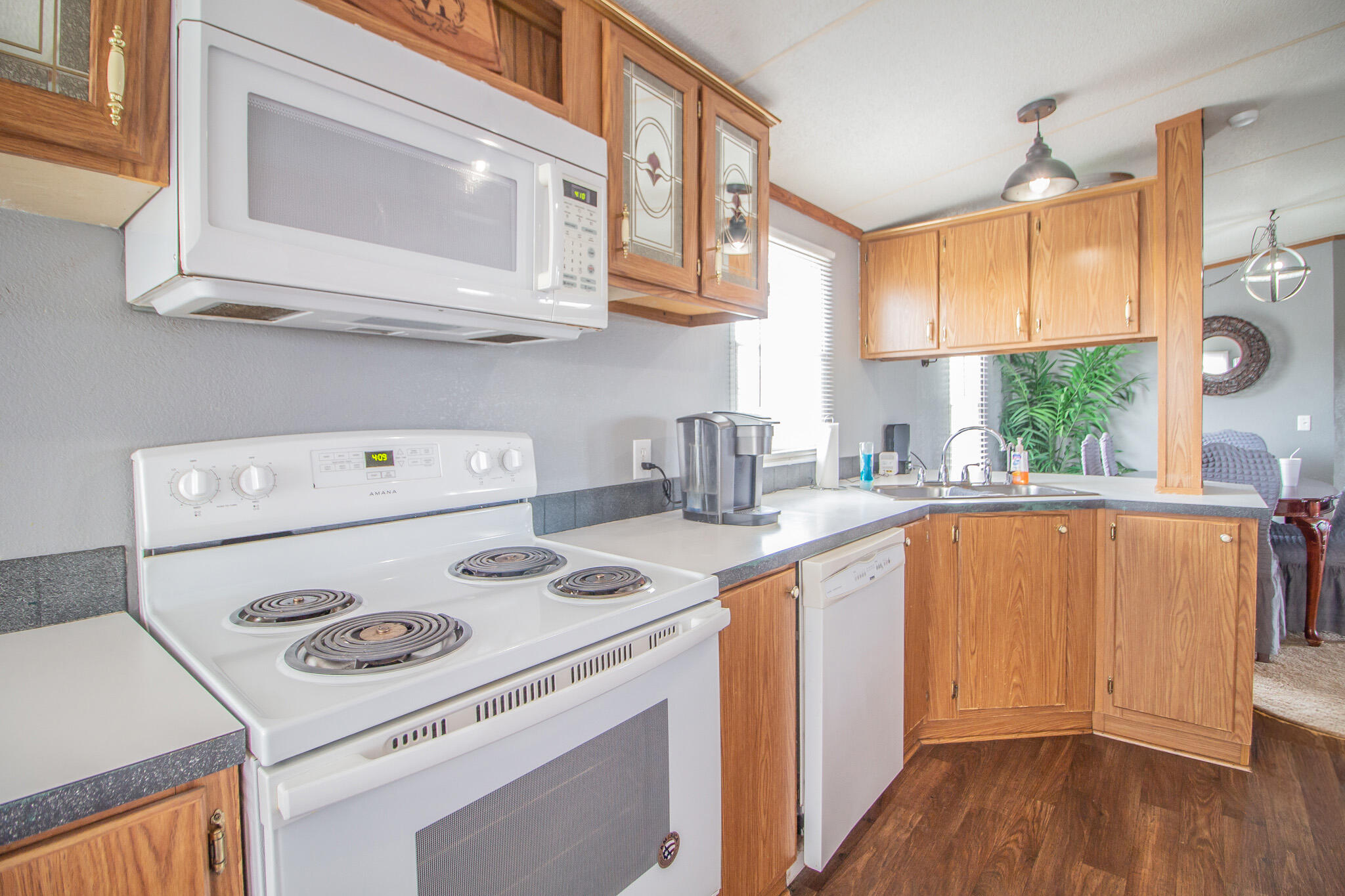 230 Bull Rider Road, Unit C Lubbock, TX 79404 - Photo 15 of 37 a kitchen with a stove a sink and a microwave
