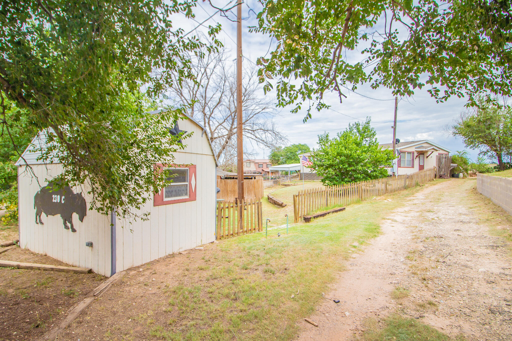 230 Bull Rider Road, Unit C Lubbock, TX 79404 - Photo 25 of 37 a house with trees in front of it