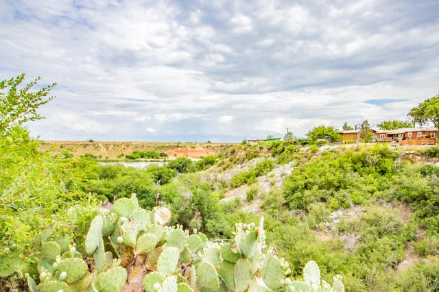 a outdoor space with lots of tables a chair and a chandelier
