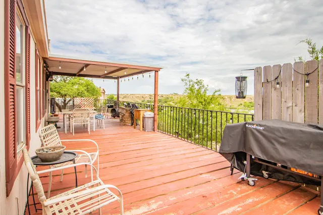 a backyard of a house with table and chairs