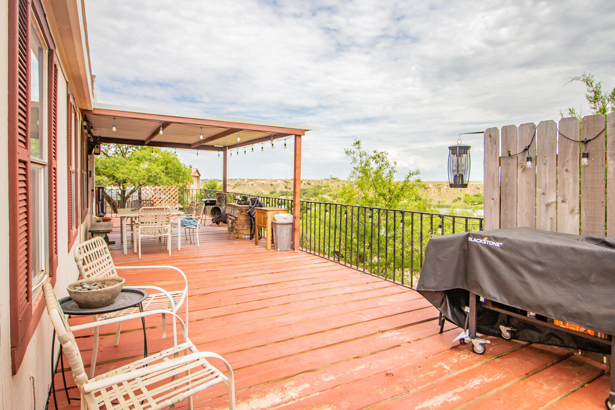 230 Bull Rider Road, Unit C Lubbock, TX 79404 - Photo 30 of 37 a balcony with table and chairs