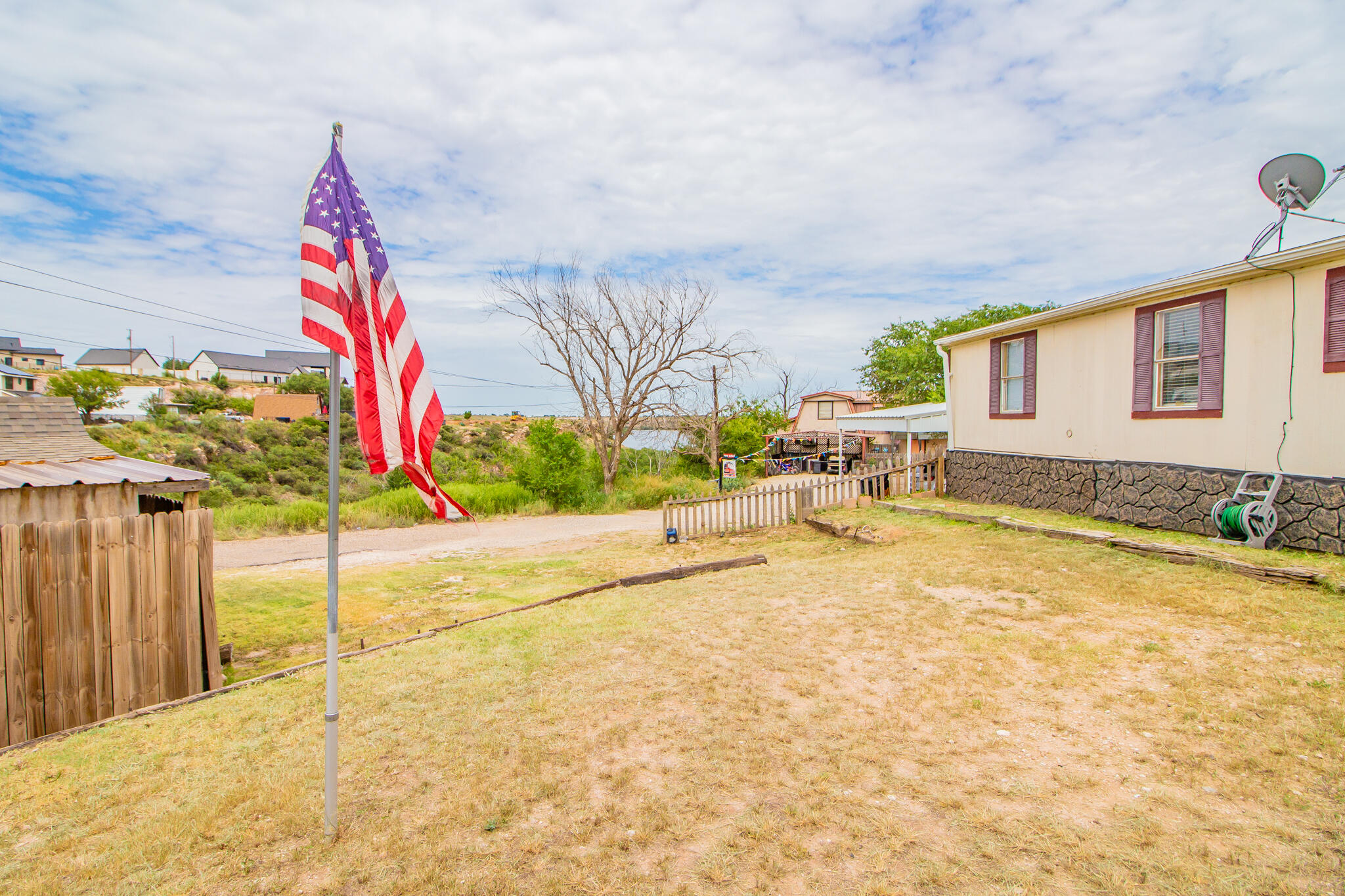 230 Bull Rider Road, Unit C Lubbock, TX 79404 - Photo 33 of 37 a backyard of a house with table and chairs