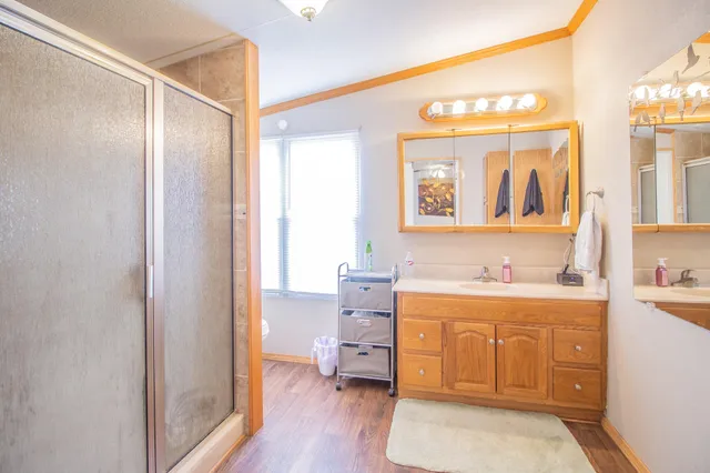 a hall with a sink cabinets and wooden floor