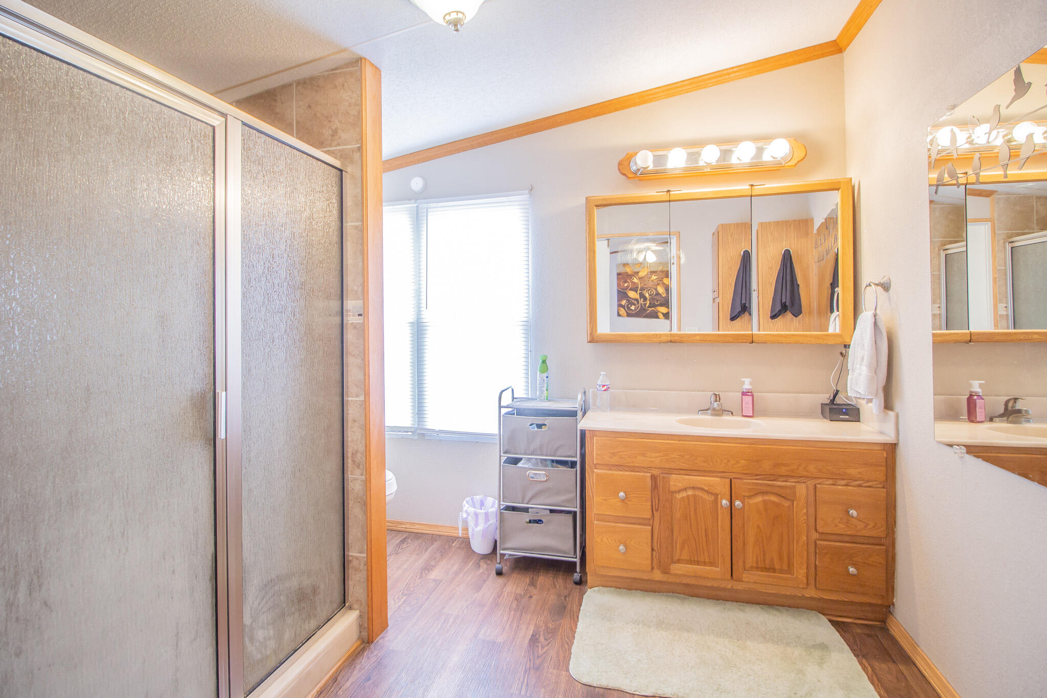 230 Bull Rider Road, Unit C Lubbock, TX 79404 - Photo 6 of 37 a hall with a sink cabinets and wooden floor