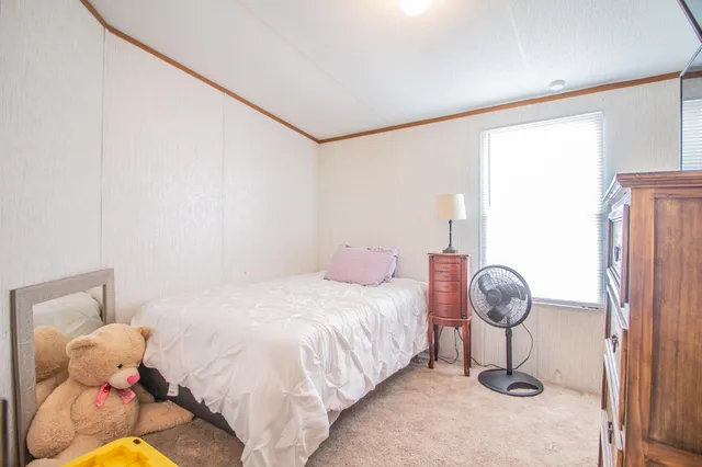 a bedroom with a bed and a window