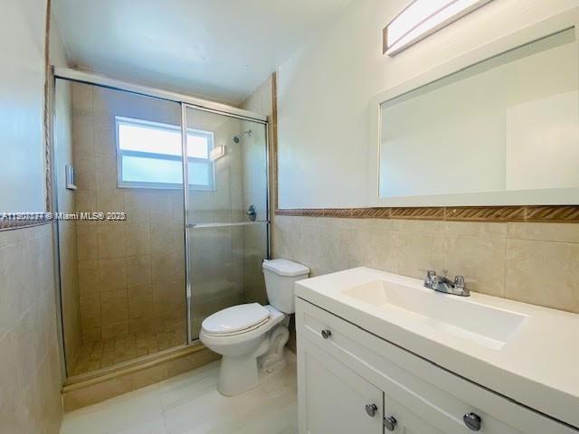 3432 Northwest 4th Street, Unit 2 Miami, FL 33125 - Photo 11 of 13 a bathroom with a sink a toilet and shower