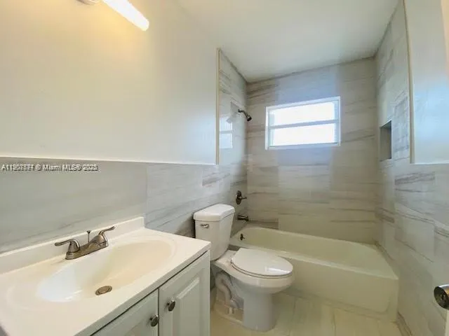 a bathroom with a sink a toilet and bathtub