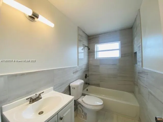 a bathroom with a sink mirror bathtub and toilet