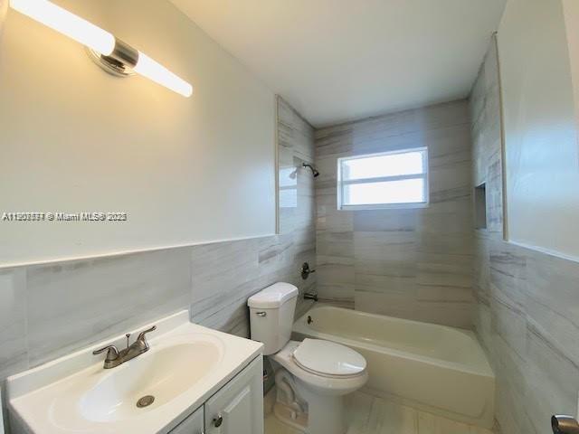 3432 Northwest 4th Street, Unit 2 Miami, FL 33125 - Photo 8 of 13 a bathroom with a sink mirror bathtub and toilet