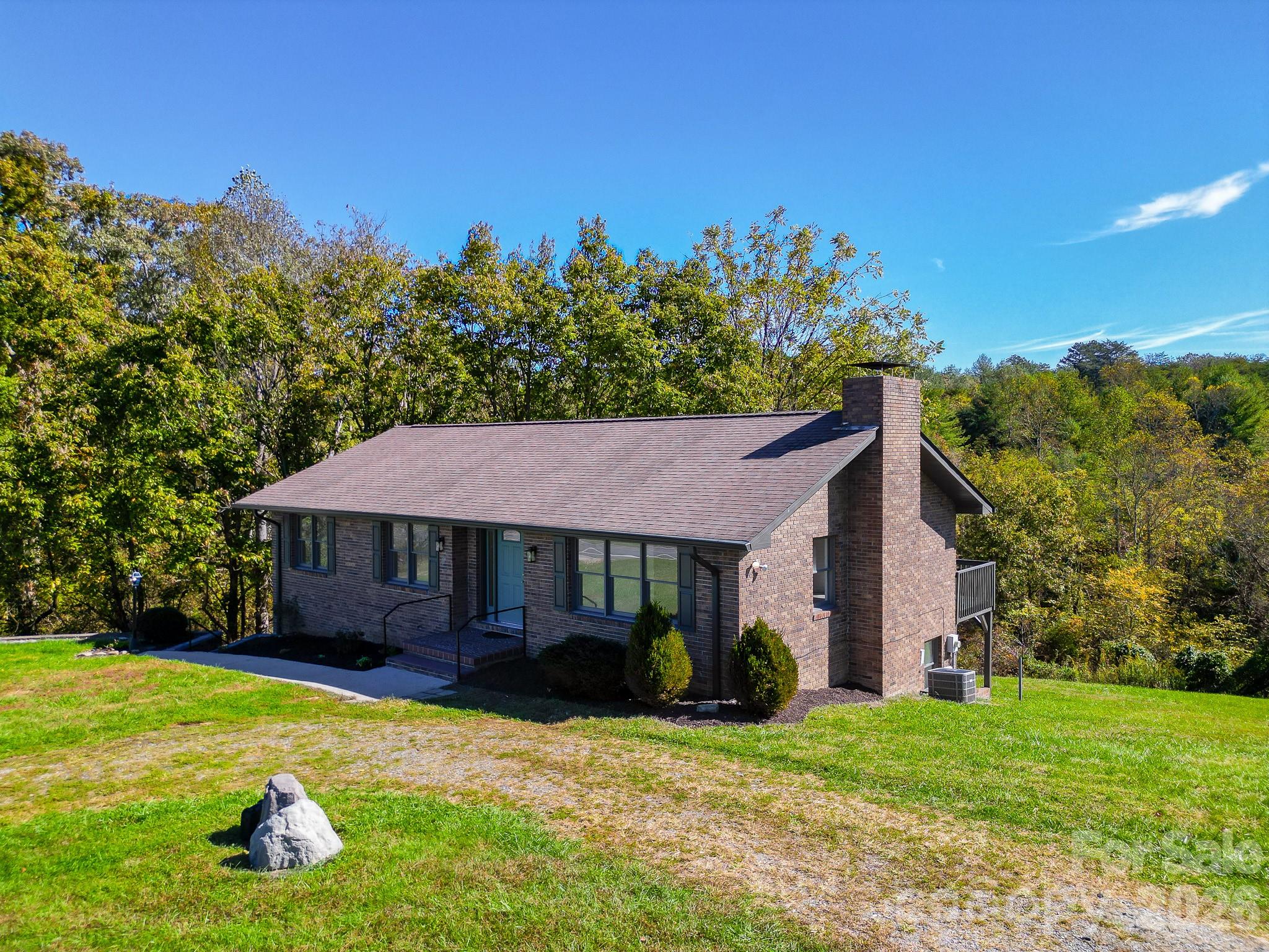1248 Jenkins Valley Road Alexander, NC 28701 - Photo 11 of 43 a front view of a house with a garden and trees