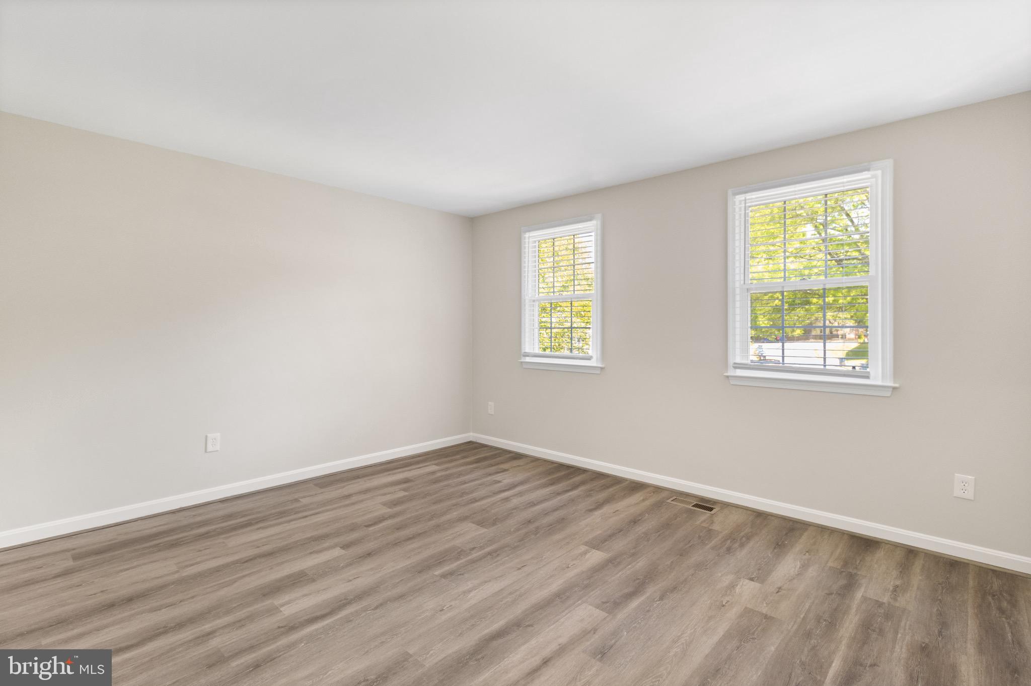 8581 Chester Grove Court Springfield, VA 22153 - Photo 20 of 38 an empty room with wooden floor and windows