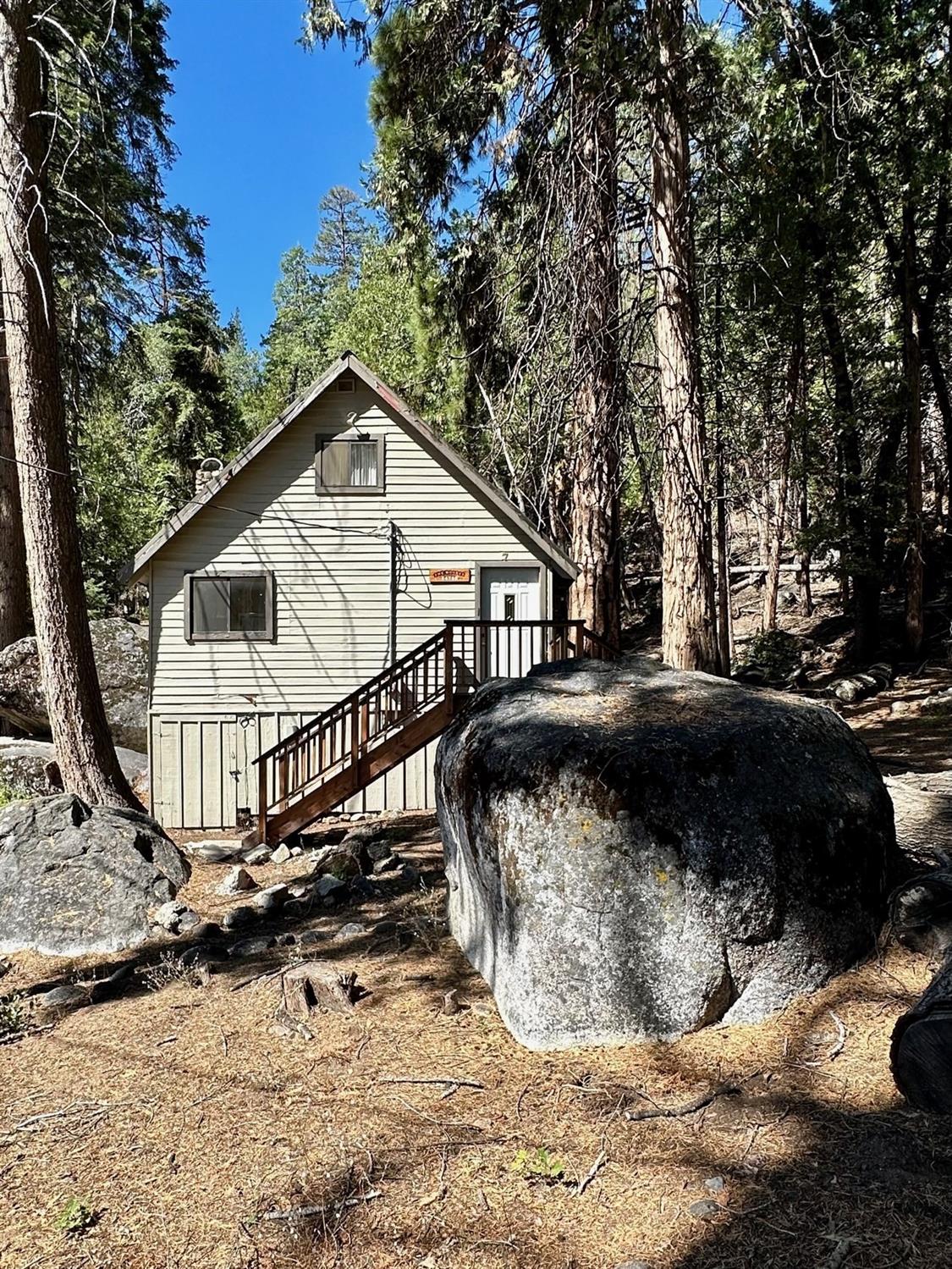 54758 Dinkey Creek Road Shaver Lake, CA 93664 - Photo 1 of 39 a view of a house with a yard covered with snow in the background